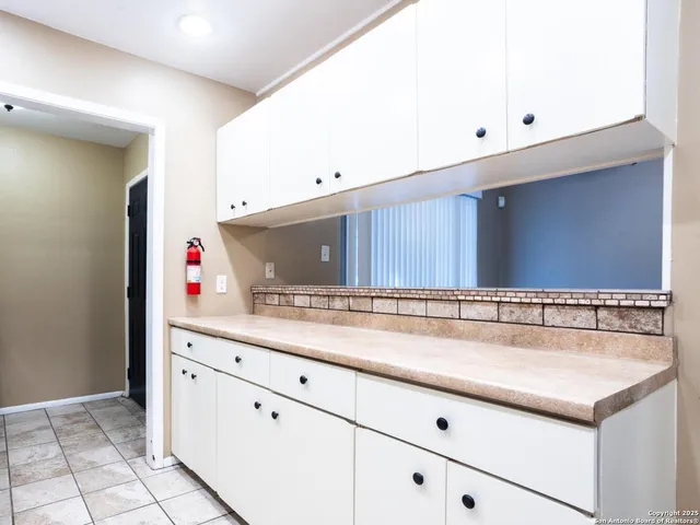 a kitchen with cabinets appliances and a sink