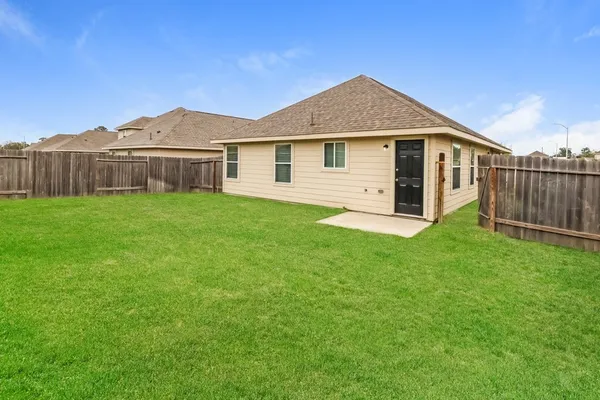 a front view of a house with yard and green space