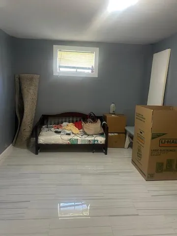 a bed room with a bed and a chair