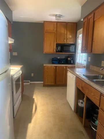 a kitchen with stainless steel appliances a stove a sink and a refrigerator