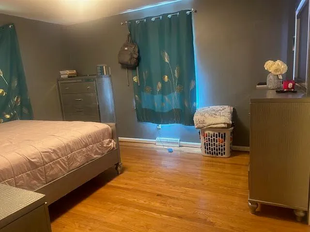 a spacious bedroom with a bed and a dresser