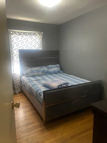 a bedroom with a bed and window