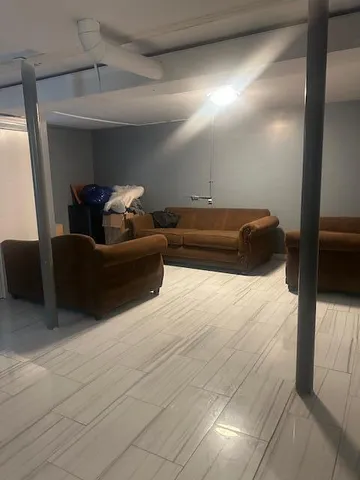 a living room with a couch and a walk in closet