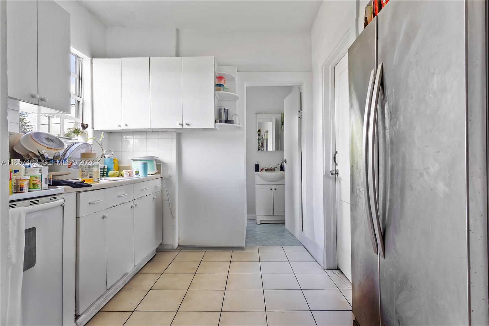 2367 Southwest 19th Street Miami, FL 33145 - Photo 16 of 24 a kitchen with white cabinets and refrigerator