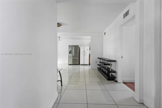a hallway with a black white checkered floor