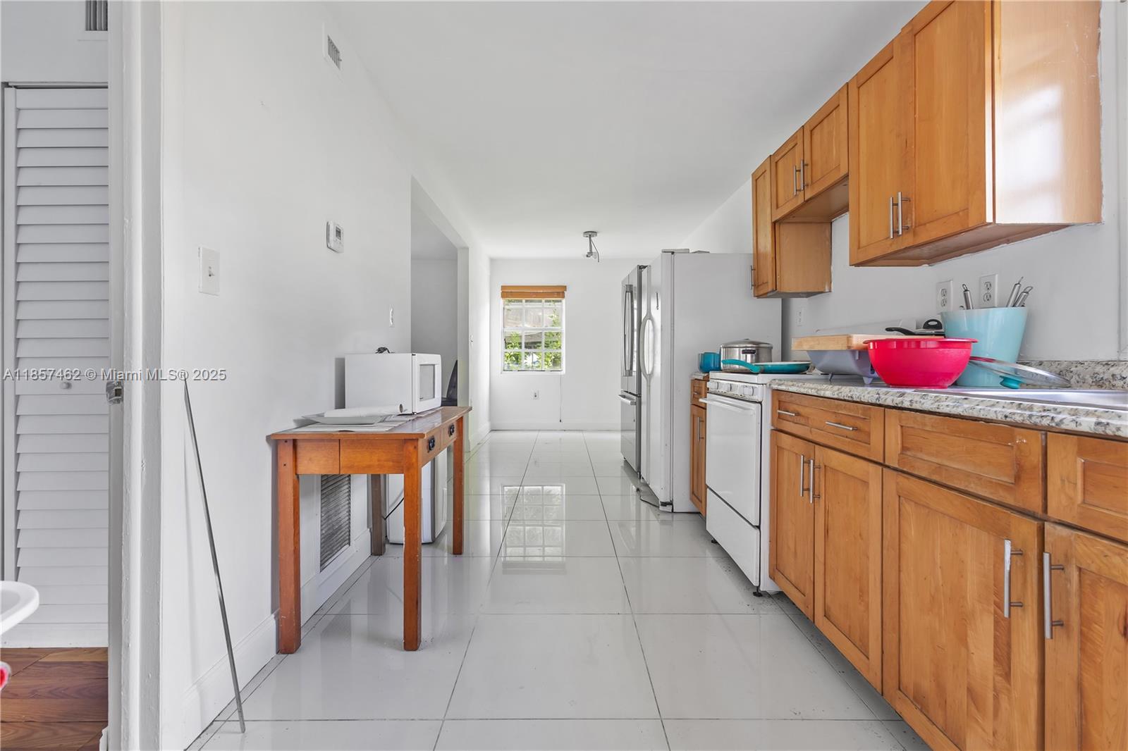 2367 Southwest 19th Street Miami, FL 33145 - Photo 21 of 24 a kitchen with stainless steel appliances a sink stove and cabinets