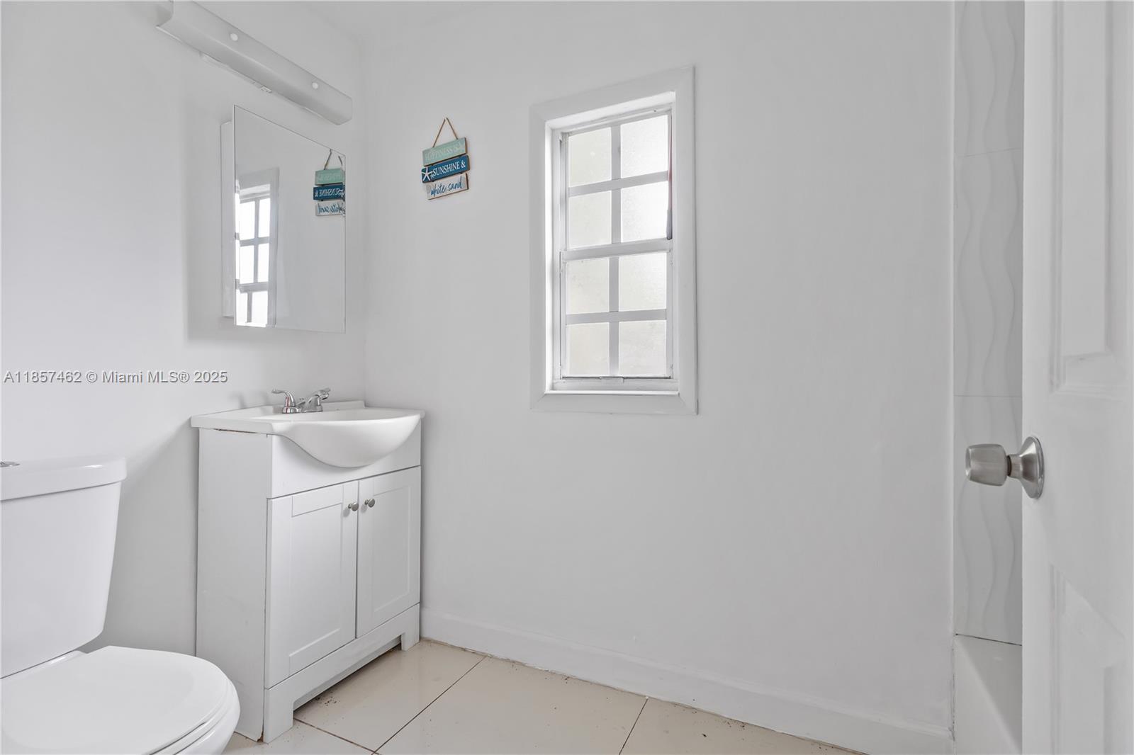 2367 Southwest 19th Street Miami, FL 33145 - Photo 22 of 24 a bathroom with a sink toilet and vanity