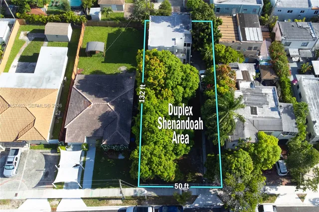 an aerial view of multiple houses with yard