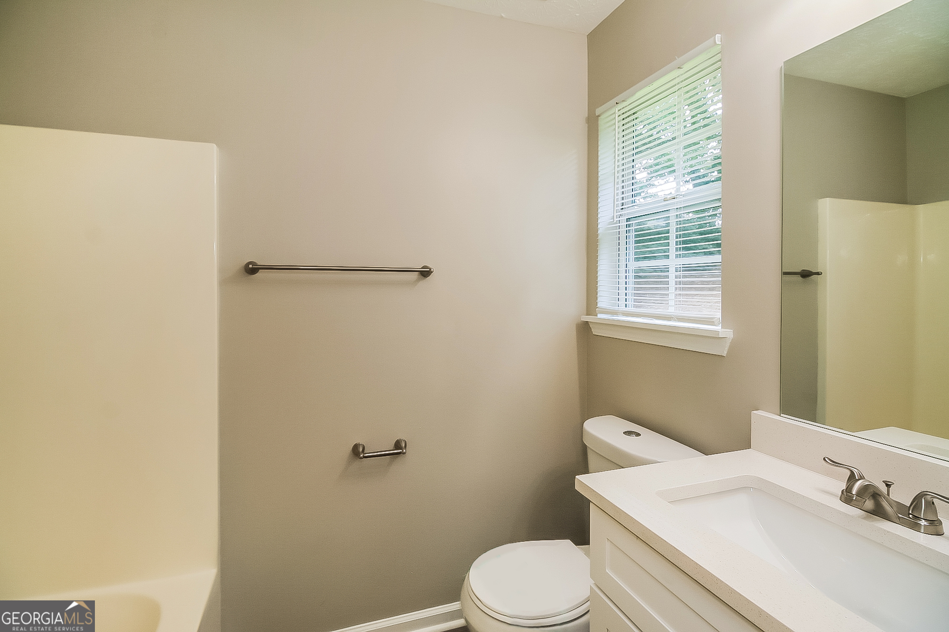 8303 Lakeview Drive Southwest Covington, GA 30014 - Photo 11 of 16 a white toilet sitting next to a bathroom sink