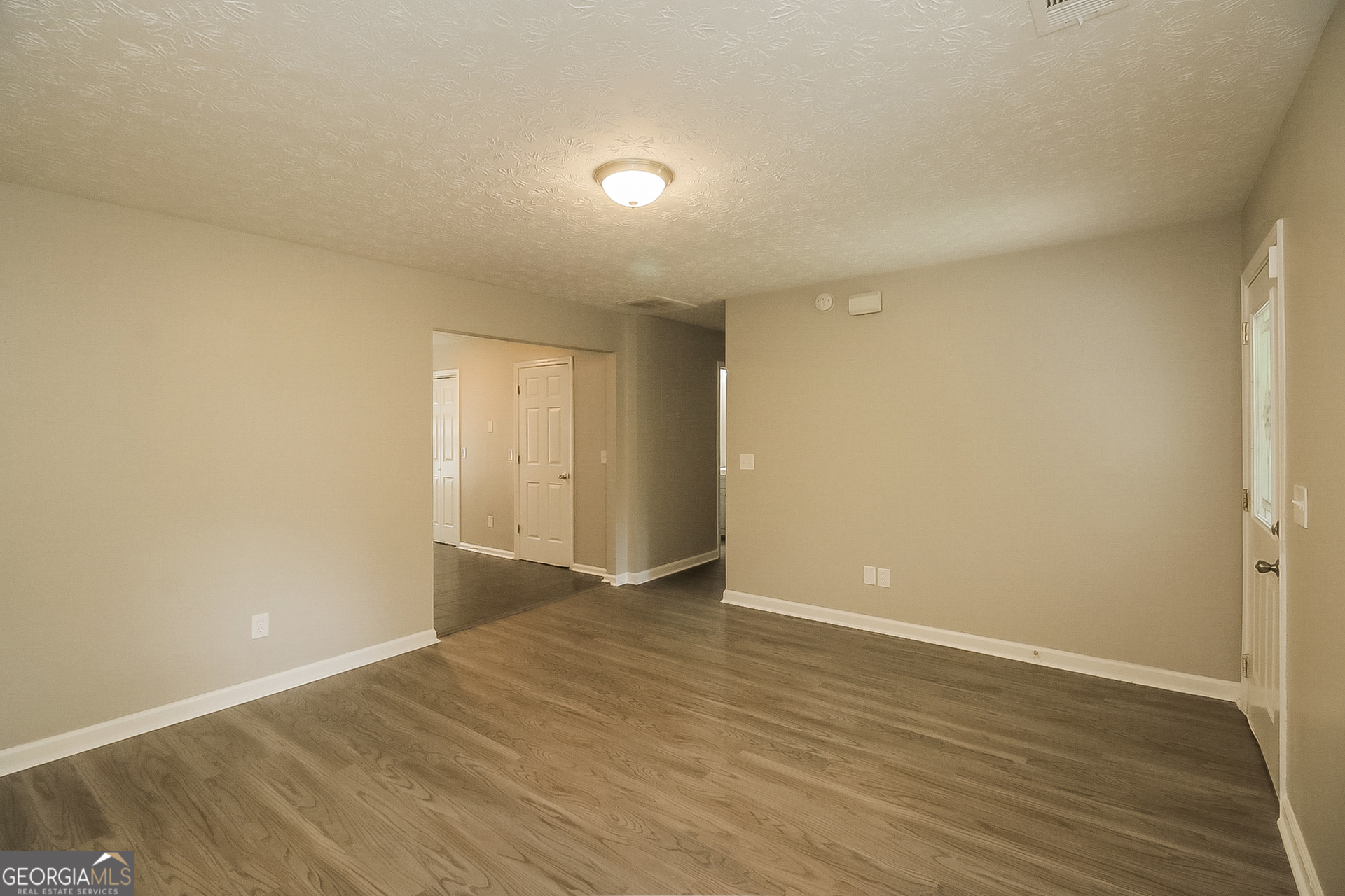 8303 Lakeview Drive Southwest Covington, GA 30014 - Photo 4 of 16 a view of an empty room with wooden floor