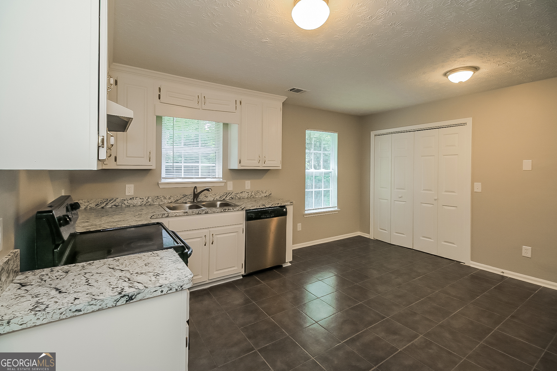 8303 Lakeview Drive Southwest Covington, GA 30014 - Photo 8 of 16 a kitchen with a sink stove and cabinets