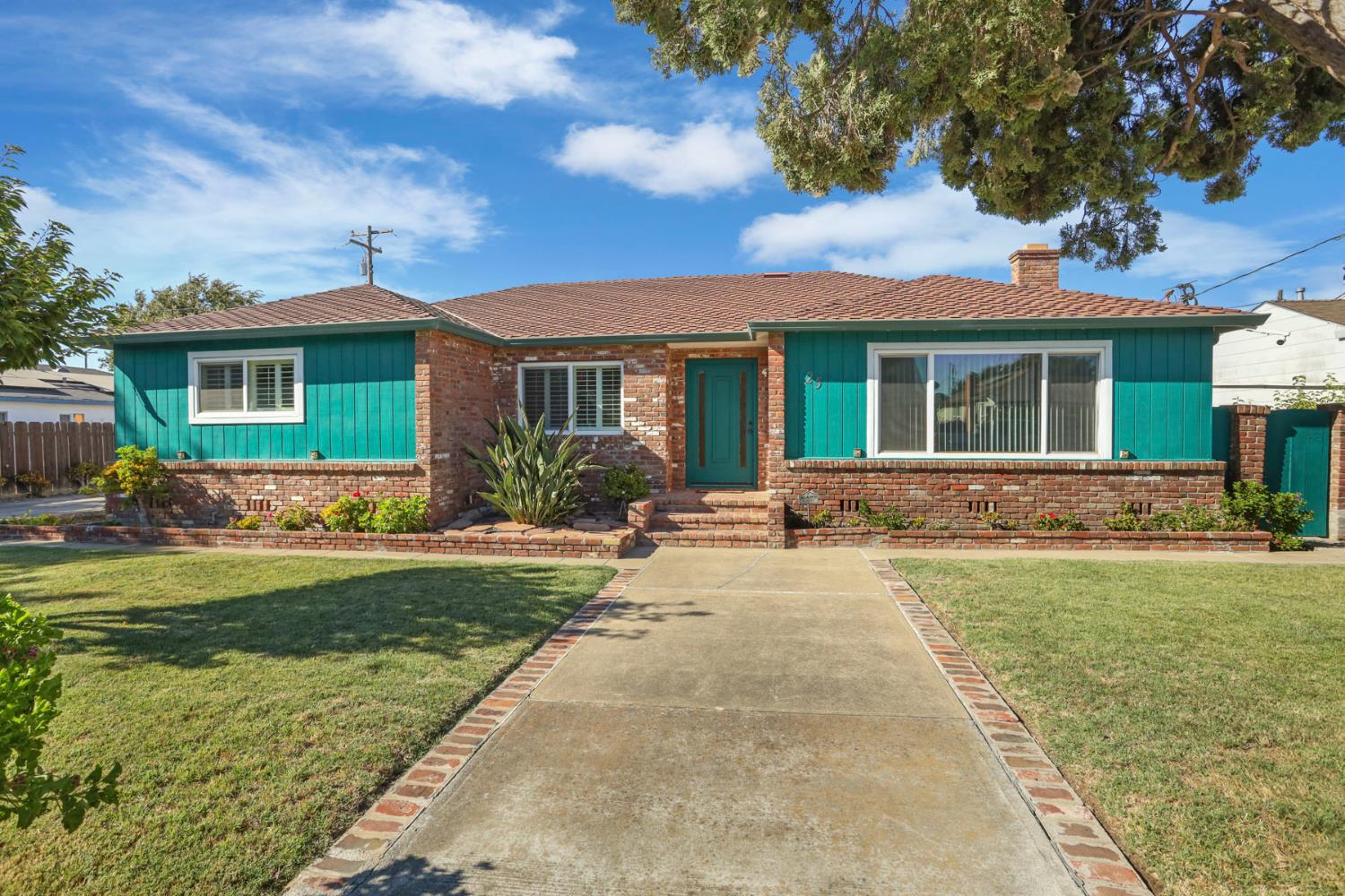 a front view of house with yard and green space
