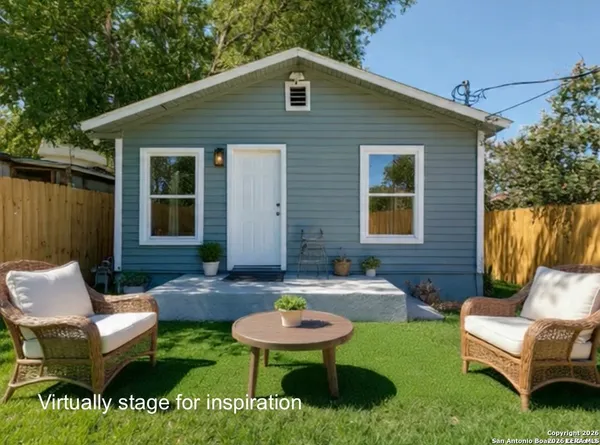 a backyard of a house with yard fire pit and outdoor seating