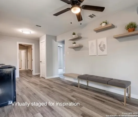a living room with furniture and a ceiling fan