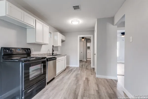 a kitchen with stainless steel appliances granite countertop a stove and a refrigerator