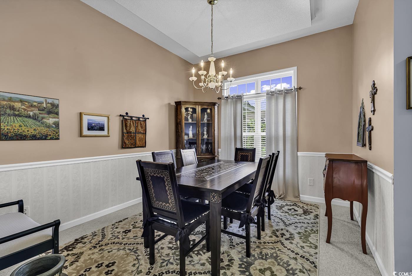 86 Black River Road Myrtle Beach, SC 29588 - Photo 11 of 40 Dining room with a chandelier, wainscoting.