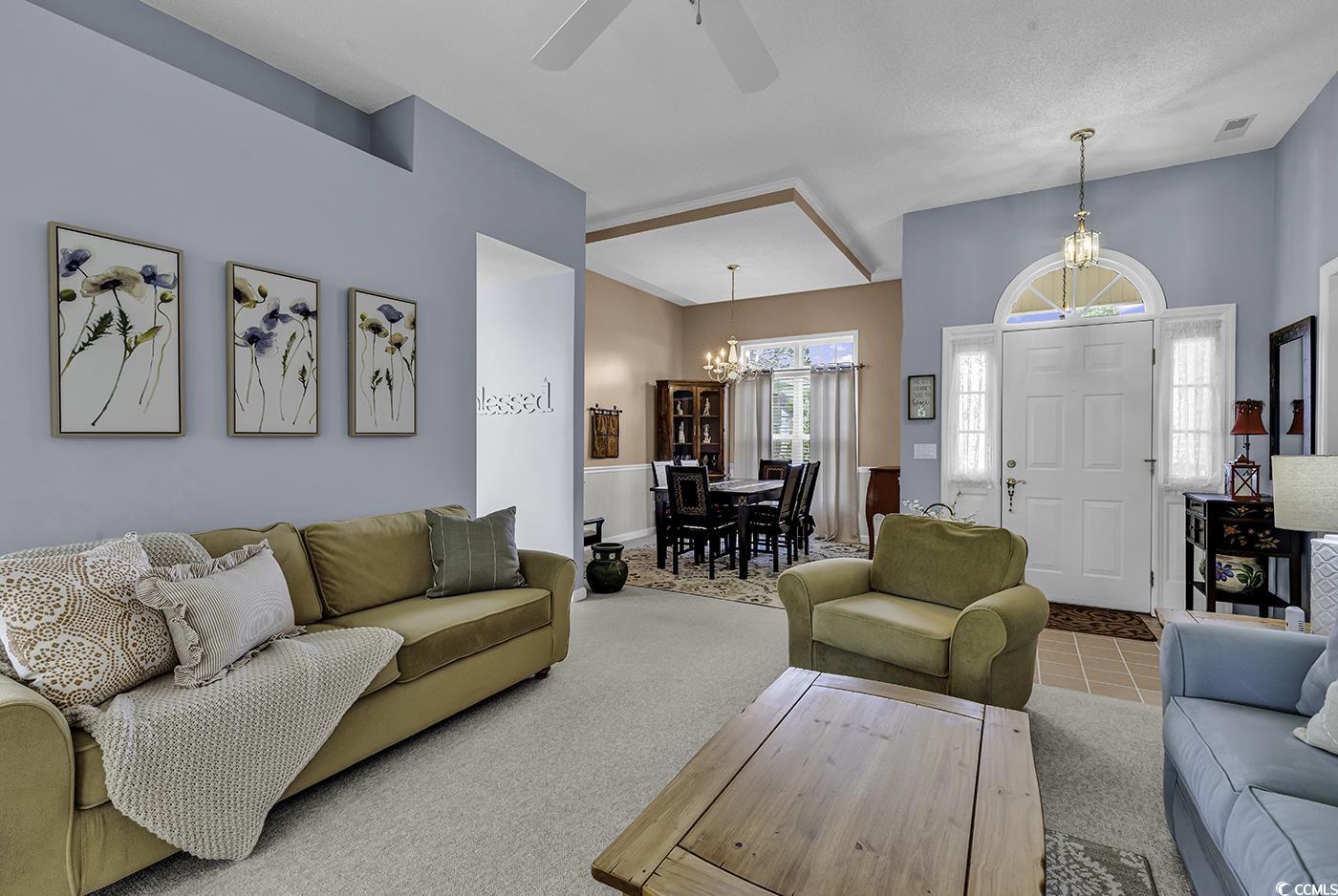 86 Black River Road Myrtle Beach, SC 29588 - Photo 5 of 40 Living room with a chandelier, ceiling fan, and carpet floors