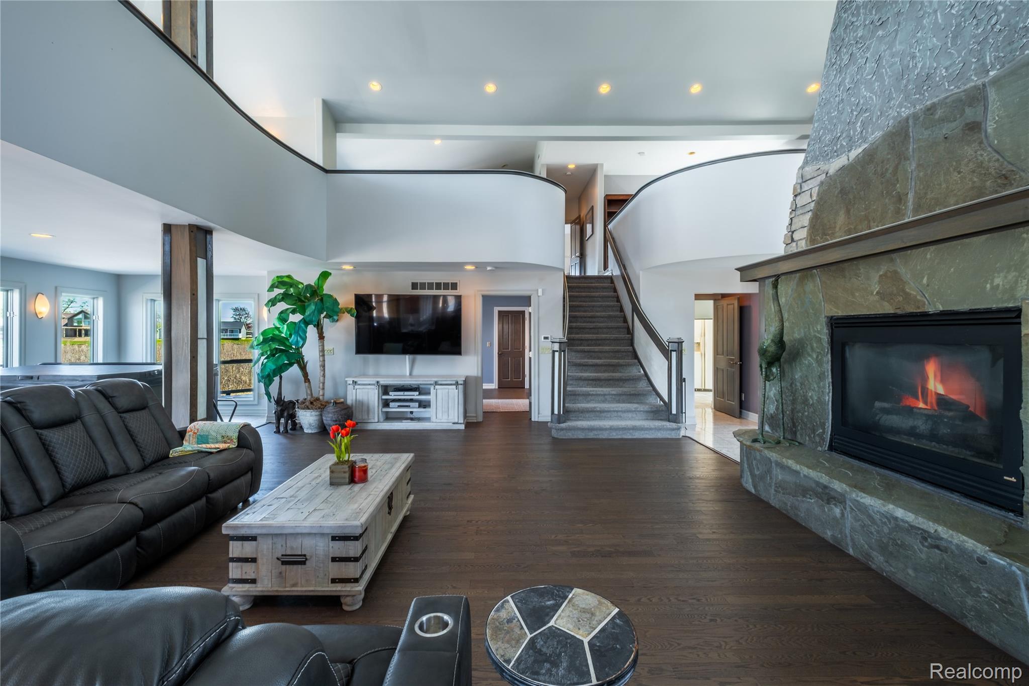 2350 Crane Road Fenton, MI 48430 - Photo 11 of 58 Living room with recessed lighting, a high ceiling, a fireplace, and dark wood-type flooring