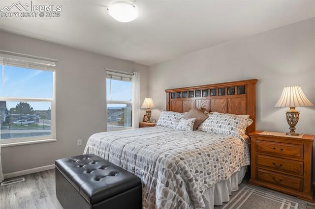 5160 Victory Road Colorado Springs, CO 80911 - Photo 12 of 31 Primary bedroom with two nice sized windows and an ensuite bathroom