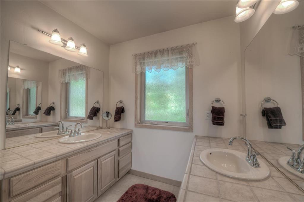 3207 High Creek Road Fairplay, CO 80440 - Photo 15 of 35 a bathroom with a sink double vanity and a mirror