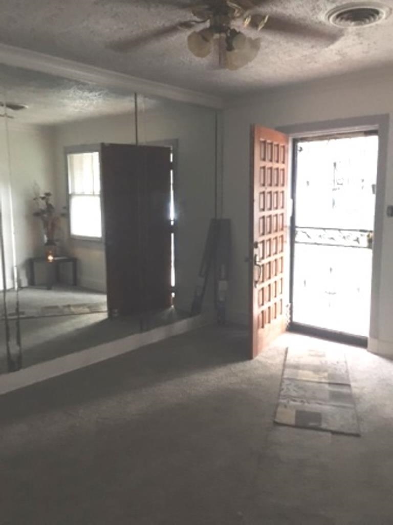 1852 Swift Street Memphis, TN 38109 - Photo 5 of 8 a view of a livingroom with a ceiling fan and window