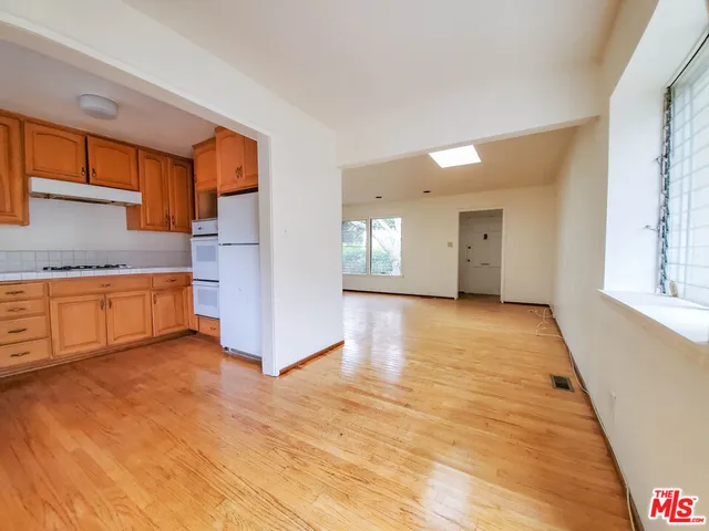 a view of a kitchen with a sink and a large window