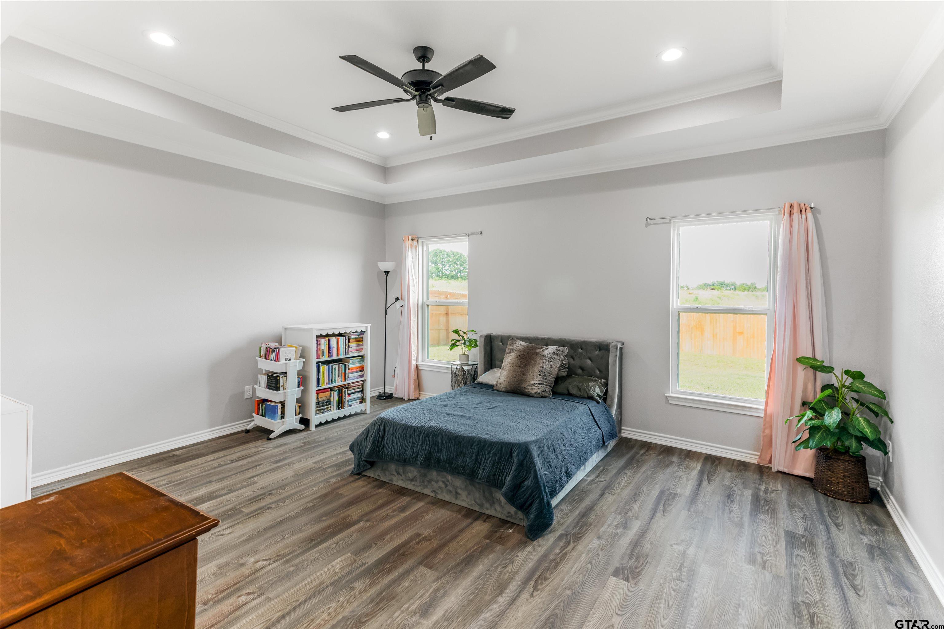 12908 County Road 46 Tyler, TX 75704 - Photo 12 of 20 a bedroom with a bed and a bookshelf