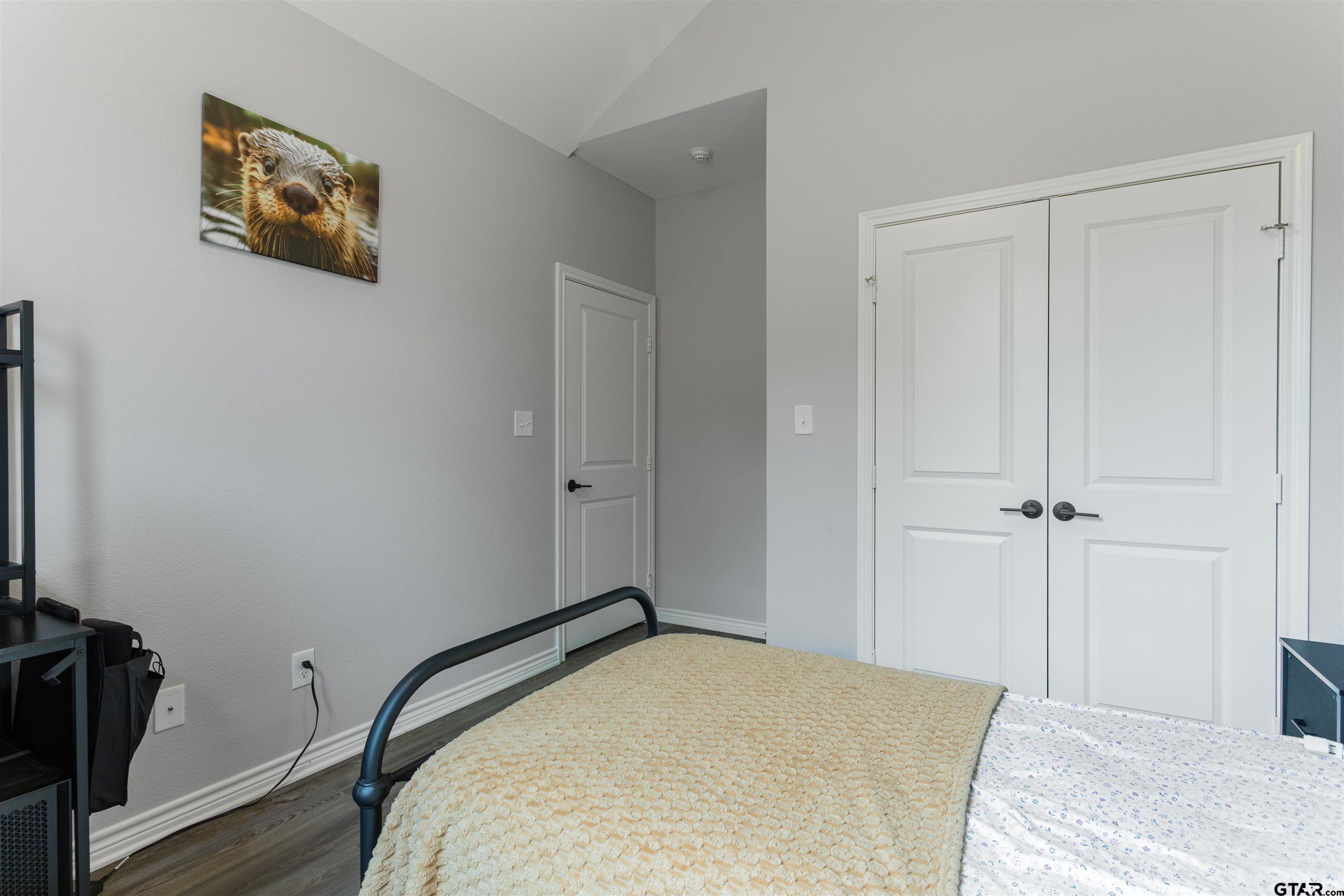 12908 County Road 46 Tyler, TX 75704 - Photo 18 of 20 a bedroom with a bed and wooden floor