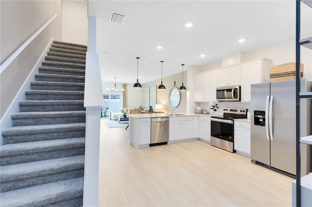 4309 Jetty Lane Palm Bay, FL 32905 - Photo 3 of 28 a kitchen with white cabinets and stainless steel appliances