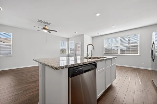 a stove top oven sitting inside of a kitchen