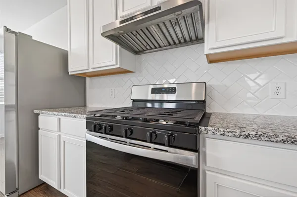 a kitchen with granite countertop a sink and a window