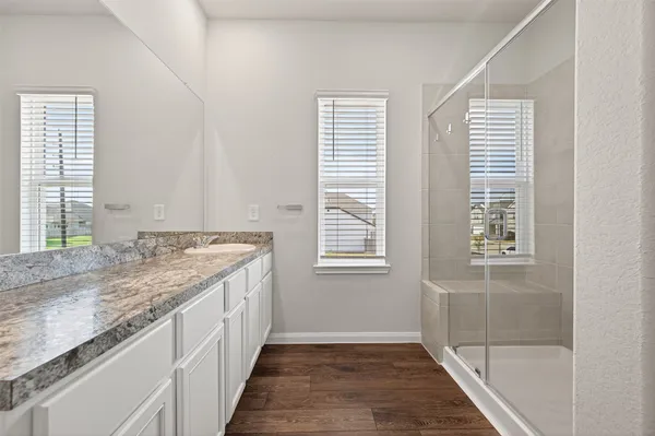 a bathroom with a granite countertop sink and a mirror