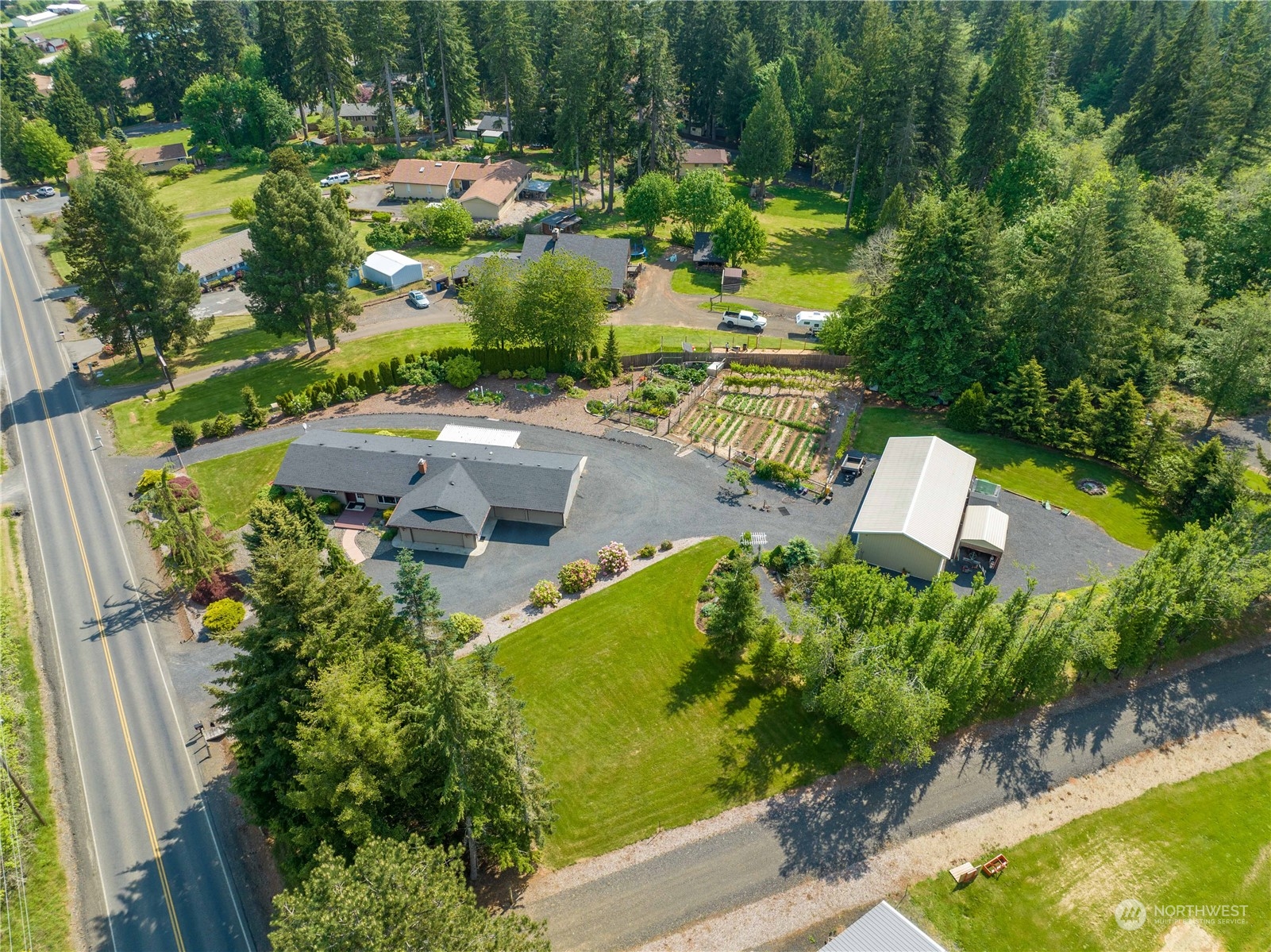 an aerial view of residential house with outdoor space and swimming pool