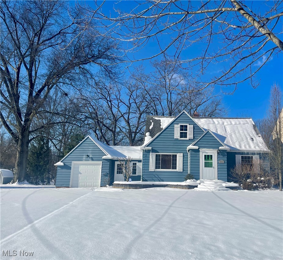 New england style home with an attached garage
