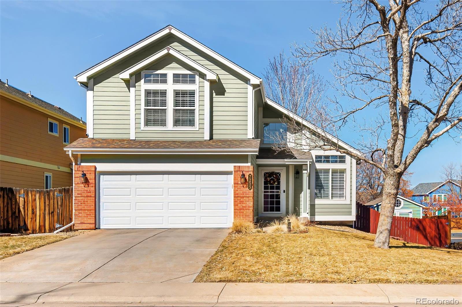 a view of a house with a yard and garage