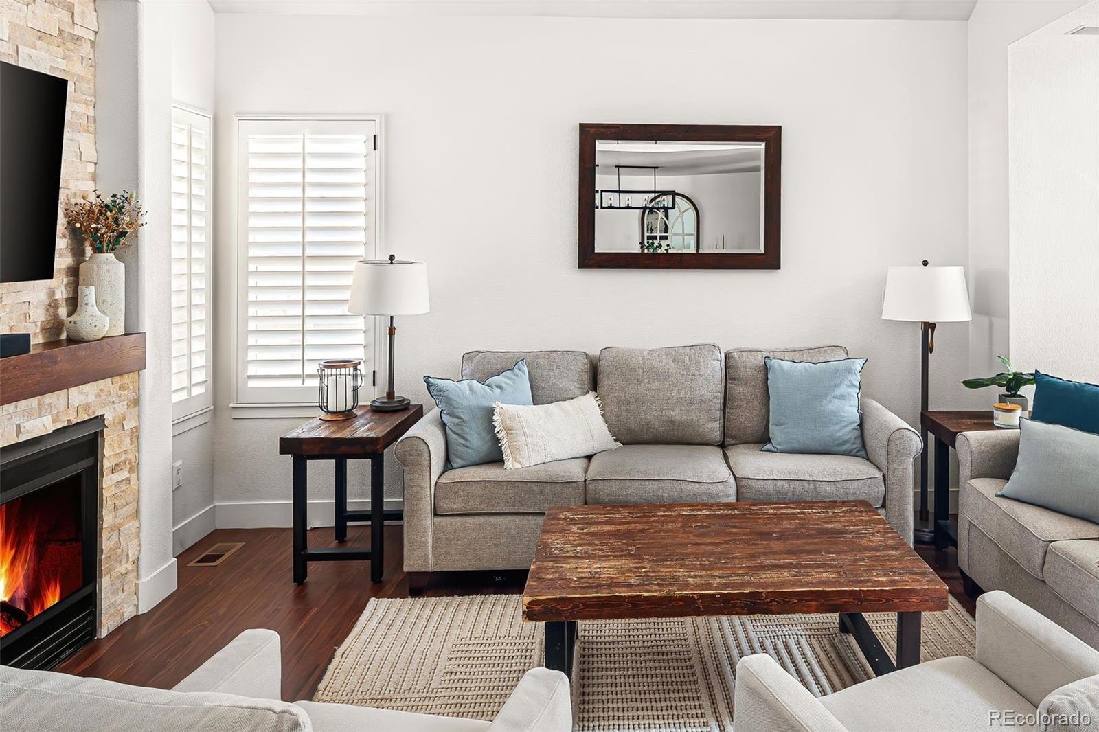 7255 West 97th Place Broomfield, CO 80021 - Photo 12 of 47 a living room with furniture and a fireplace