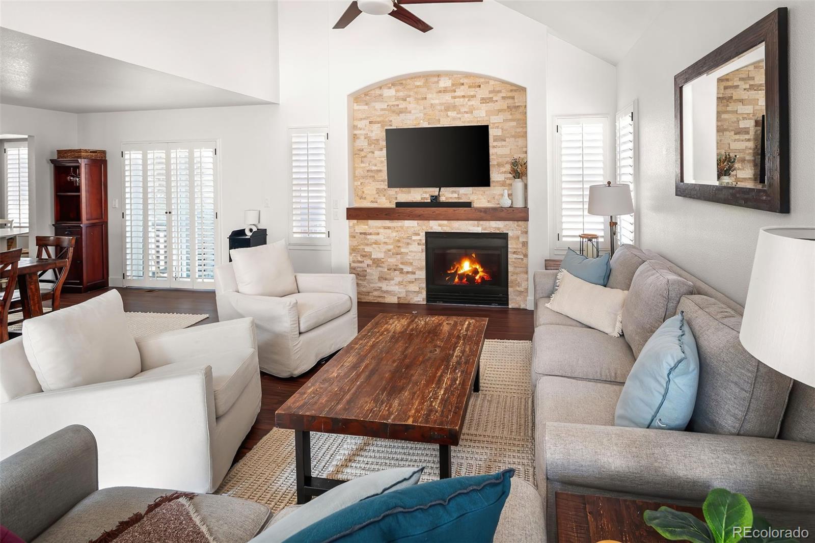 7255 West 97th Place Broomfield, CO 80021 - Photo 13 of 47 a living room with furniture a fireplace and a flat screen tv