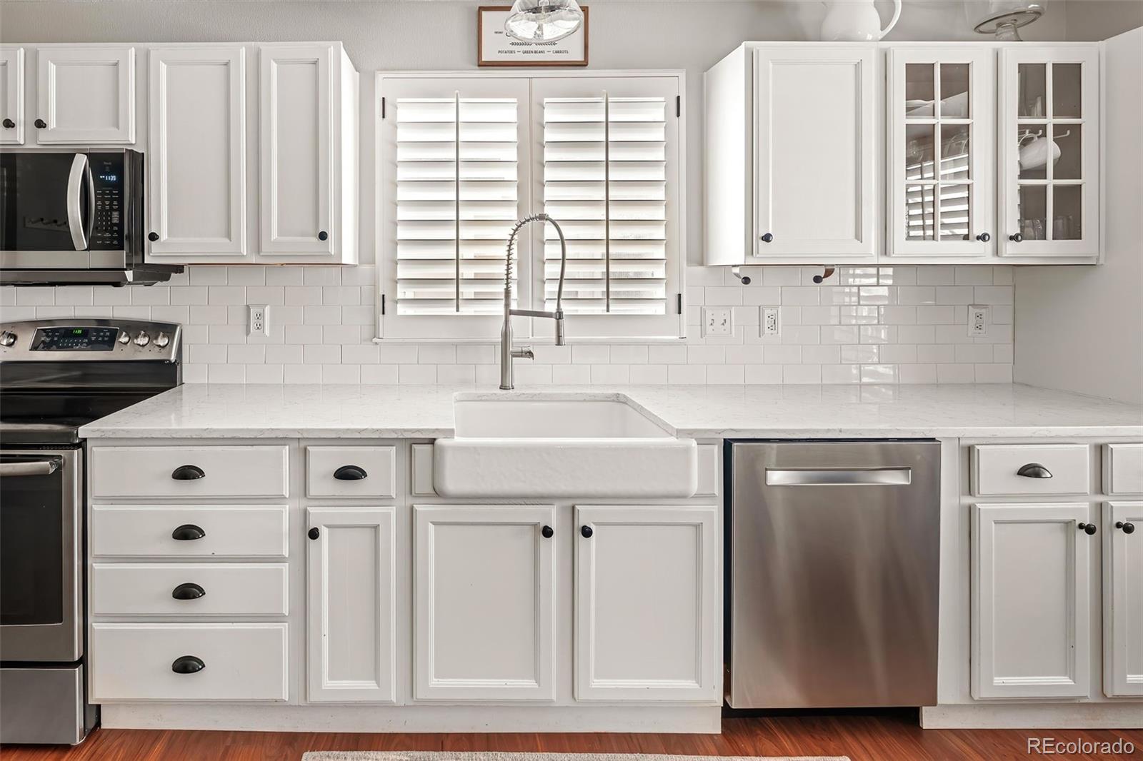 7255 West 97th Place Broomfield, CO 80021 - Photo 20 of 47 a kitchen with stainless steel appliances cabinets and a window