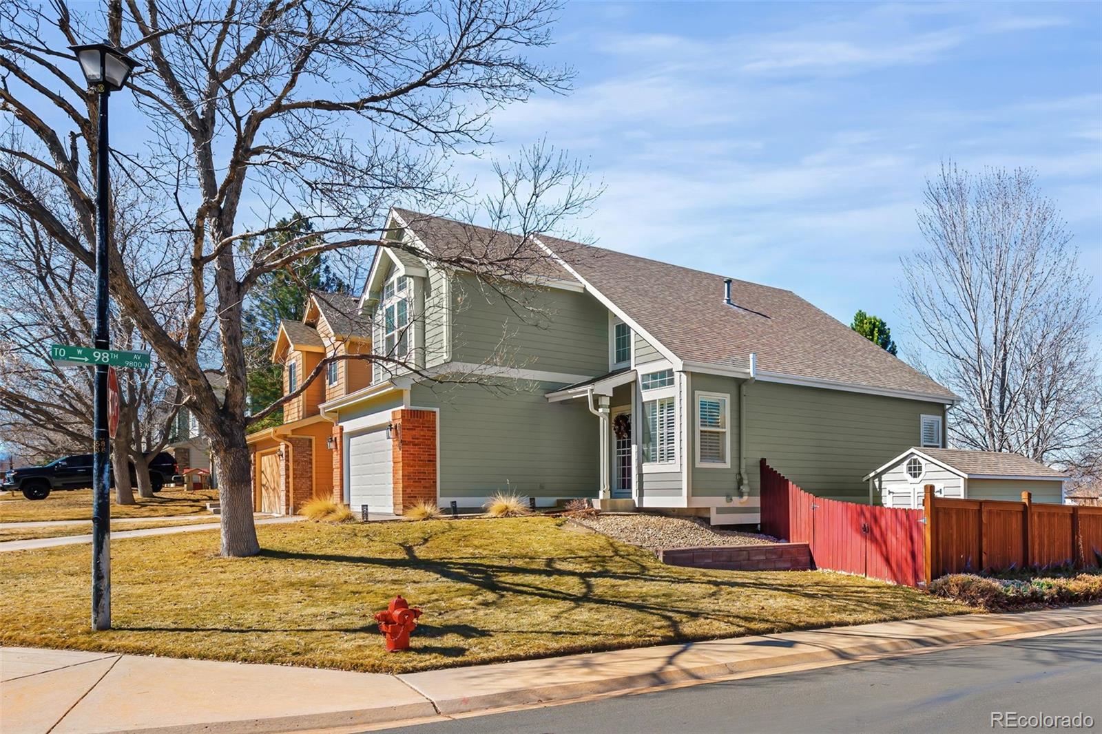 7255 West 97th Place Broomfield, CO 80021 - Photo 2 of 47 a view of a white house with a large tree and yard