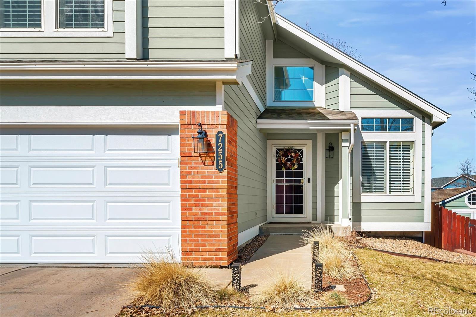 7255 West 97th Place Broomfield, CO 80021 - Photo 3 of 47 a front view of a house with a yard