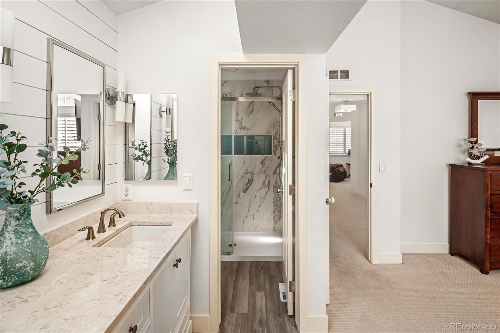 7255 West 97th Place Broomfield, CO 80021 - Photo 31 of 47 a bathroom with a granite countertop tub sink and mirror