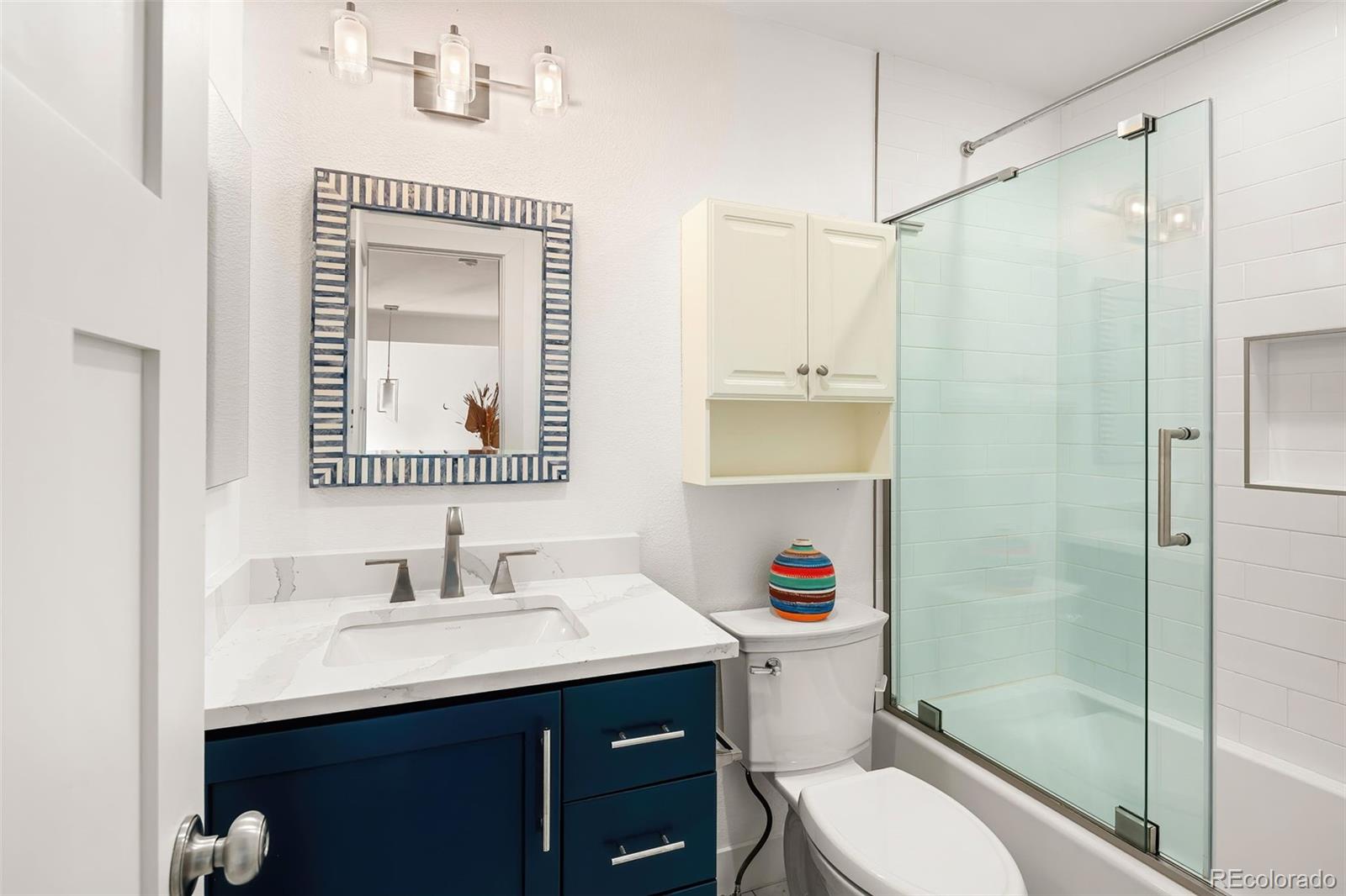 7255 West 97th Place Broomfield, CO 80021 - Photo 34 of 47 a bathroom with a sink vanity mirror and toilet