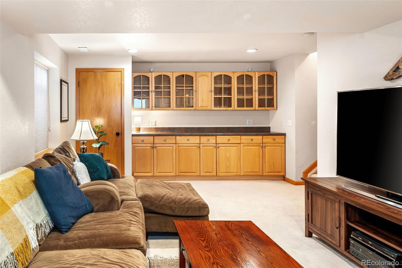 7255 West 97th Place Broomfield, CO 80021 - Photo 36 of 47 a living room with furniture and a flat screen tv