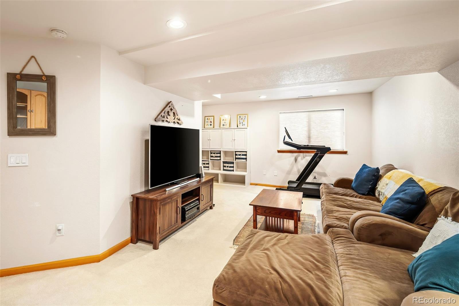 7255 West 97th Place Broomfield, CO 80021 - Photo 37 of 47 a living room with furniture and a flat screen tv