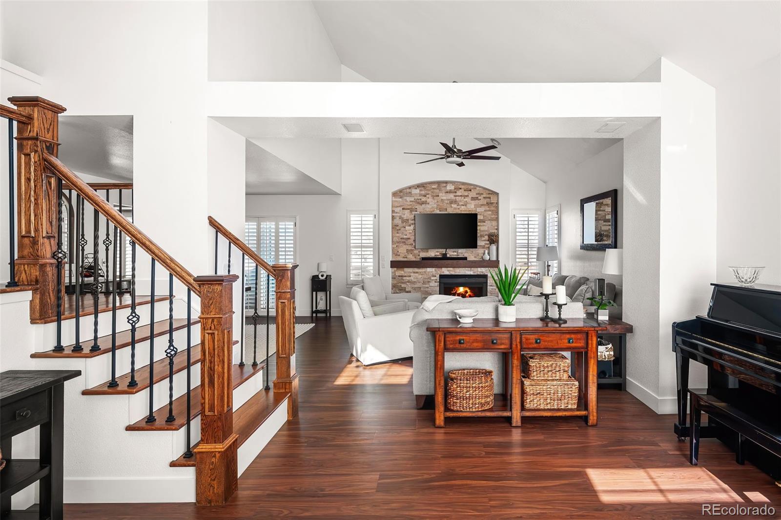 7255 West 97th Place Broomfield, CO 80021 - Photo 6 of 47 a living room with furniture a fireplace and a flat screen tv
