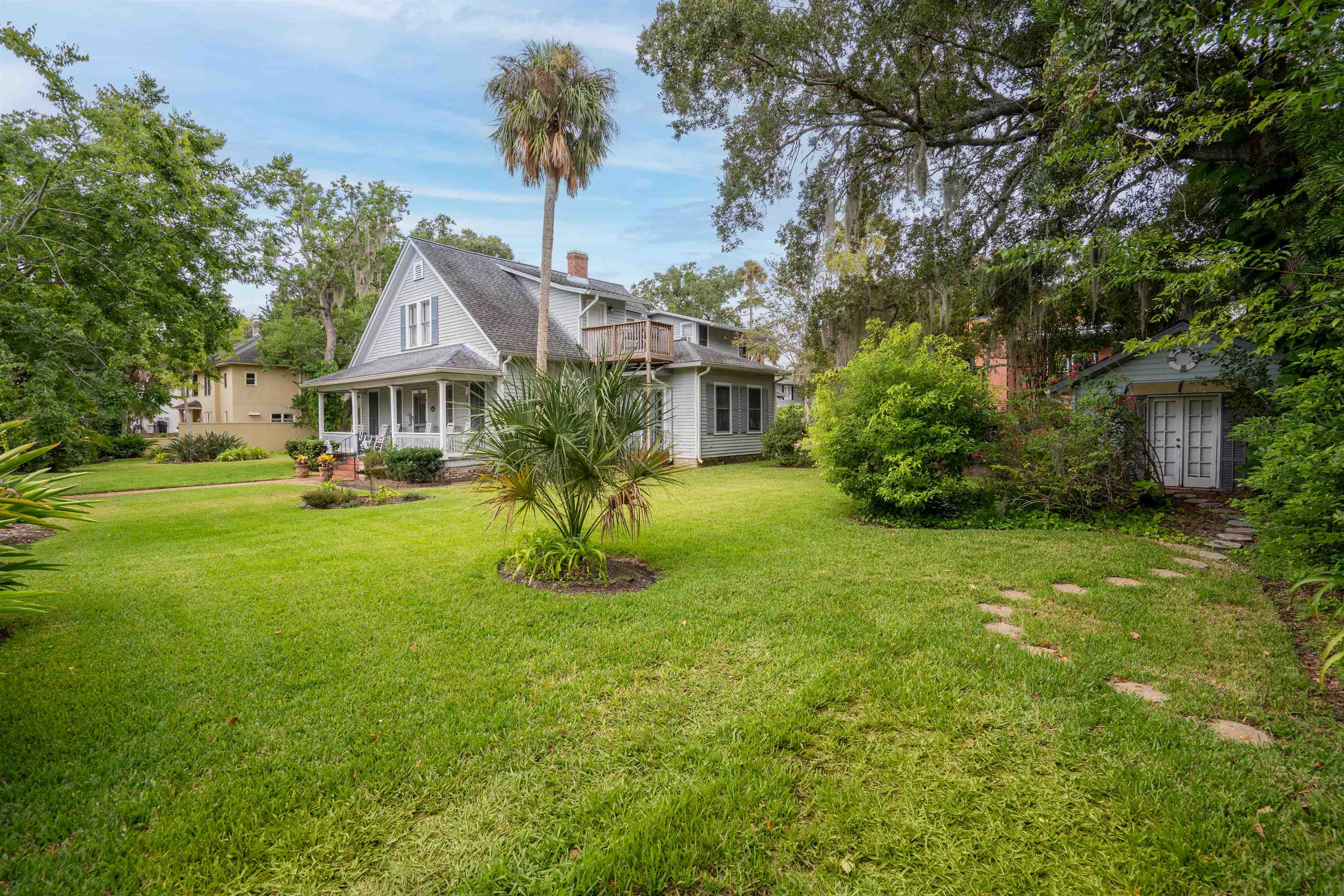 142 Marine Street St. Augustine, FL 32084 - Photo 2 of 48 a front view of a house with a yard table and chairs