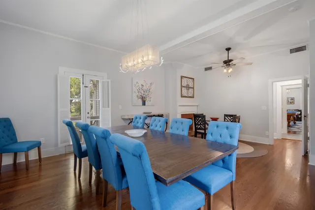 a view of a dining room with furniture wooden floor and chandelier