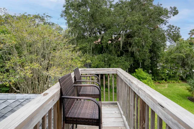 a view of balcony with wooden floor and fence