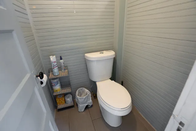 a white toilet sitting next to a small sink