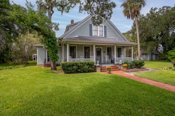 a front view of house with yard and outdoor seating